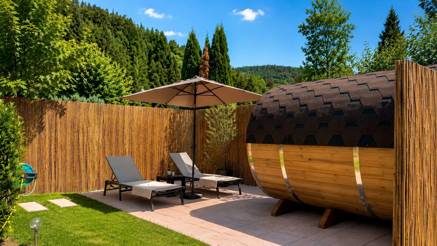 Barrel sauna with loungers in the garden