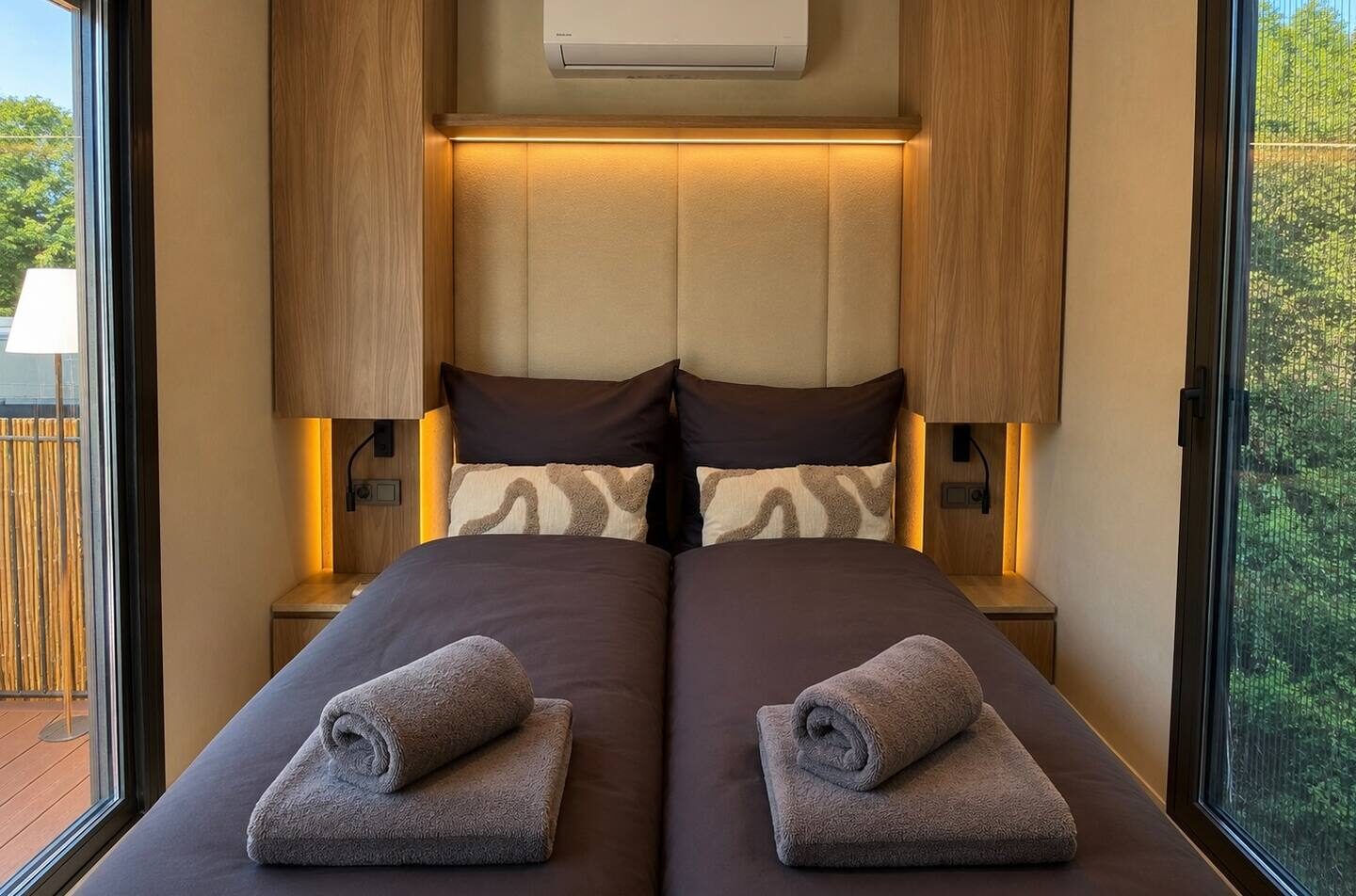 Sleeping area with double bed and ambient lighting